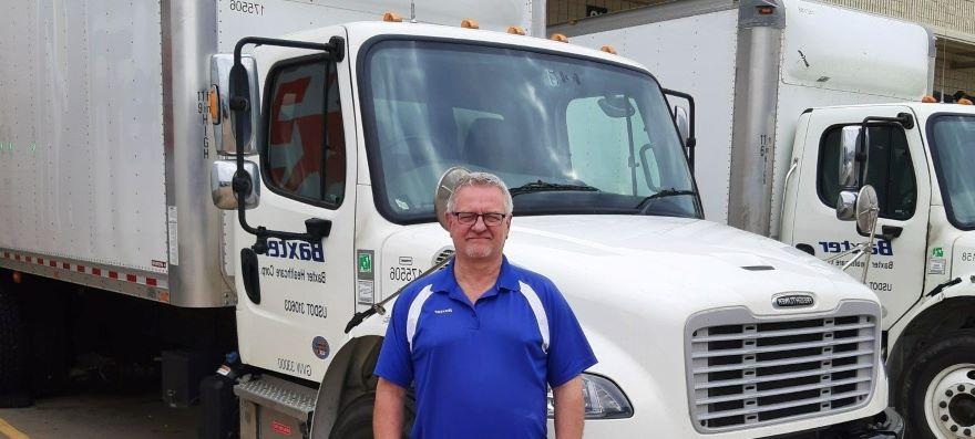 man standing in front of a white truck 